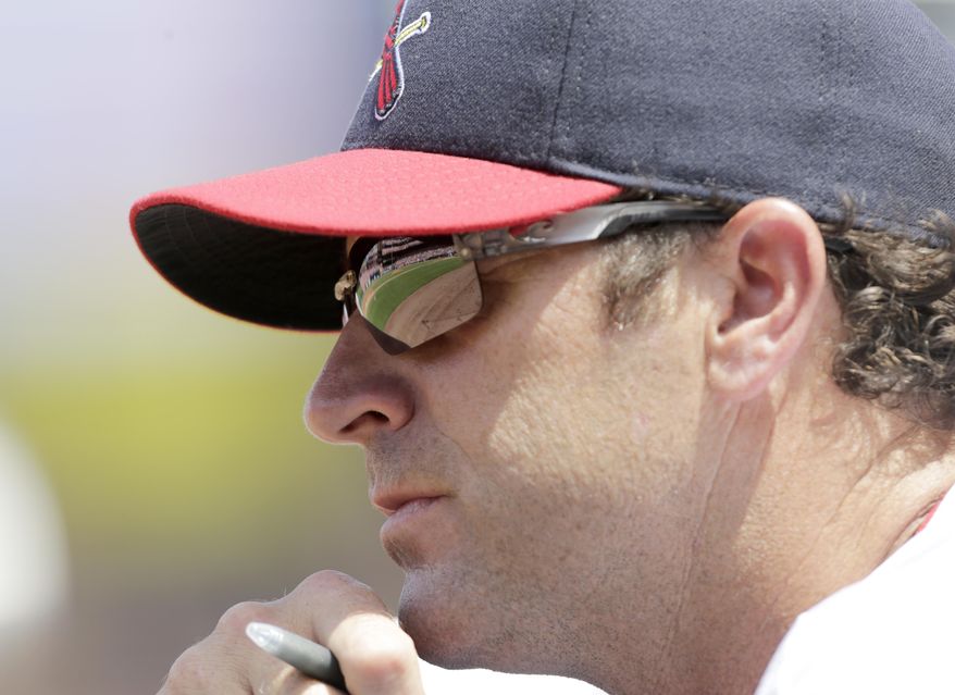 FILE - In this Aug. 7, 2016, file photo, St. Louis Cardinals manager Mike Matheny watches from the dugout in the second inning of a baseball game against the Atlanta Braves in St. Louis. Matheny has taken on a new role this spring, the Cardinals' self-proclaimed "glove breakerinner guy," working over new leather during his spare time. (AP Photo/Tom Gannam, File)
