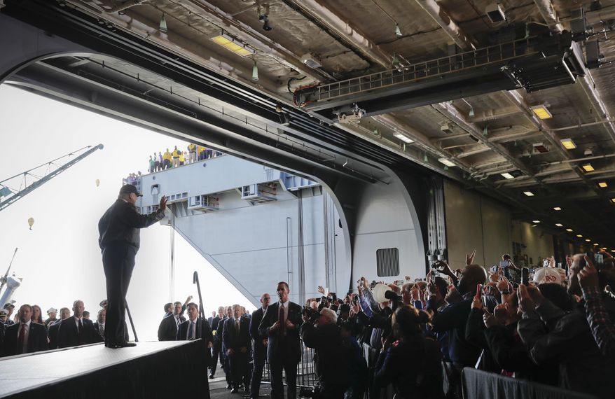 FILE - In this Thursday, March 2, 2017, file photo, President Donald Trump waves to Navy and shipyard personnel aboard nuclear aircraft carrier Gerald R. Ford at Newport News Shipbuilding in Newport News, Va. The ship, which is still under construction, is due to be delivered to the Navy later in the year. The area around the Virginia shipyard where Trump visited is just the kind of place that would likely feel the greatest economic impact from his requested $54 billion increase in defense spending. But outside of that kind of local impact near the shipyards or jet factories receiving additional money, experts say the increased defense spending wouldn't make much difference overall. (AP Photo/Pablo Martinez Monsivais, File)