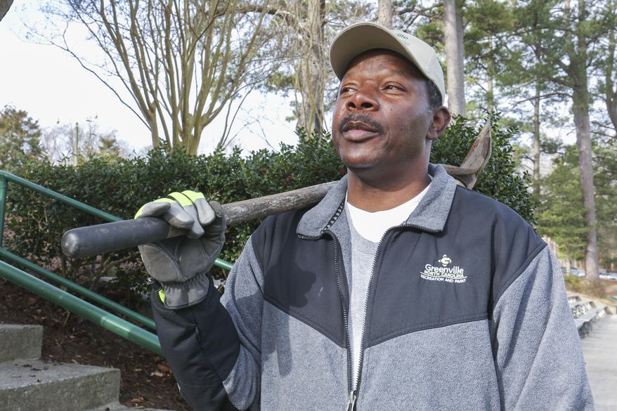 ADVANCE FOR RELEASE SATURDAY, MARCH 11, 2017, AT 12:01 A.M. EST - In this Feb. 23, 2017, photo, Greenville Recreation and Parks employee, Mark Dixon holds a shovel with a sand spreader at Elm Street Park in Greenville, N.C. Spring may officially be a few weeks away, but many in eastern North Carolina also know that March often delivers snow. (Juliette Cooke/The Daily Reflector via AP)