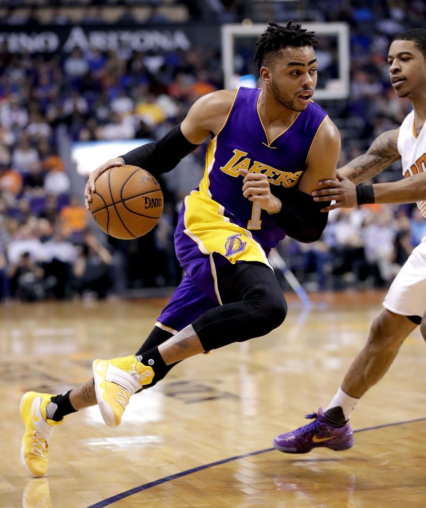 Los Angeles Lakers guard D'Angelo Russell (1) drives past Phoenix Suns guard Tyler Ulis during the first half of an NBA basketball game, Thursday, March 9, 2017, in Phoenix. (AP Photo/Matt York)