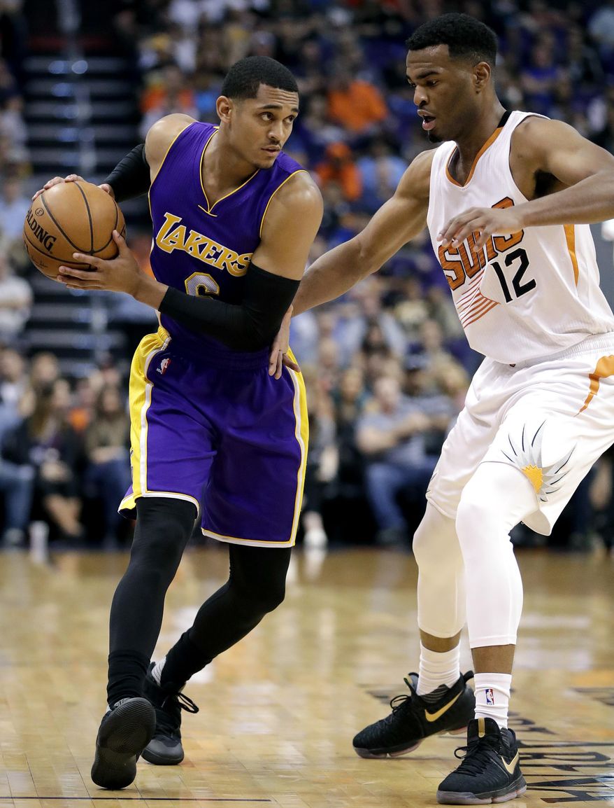 Los Angeles Lakers guard Jordan Clarkson (6) looks to pass around Phoenix Suns forward TJ Warren (12) during the first half of an NBA basketball game, Thursday, March 9, 2017, in Phoenix. (AP Photo/Matt York)