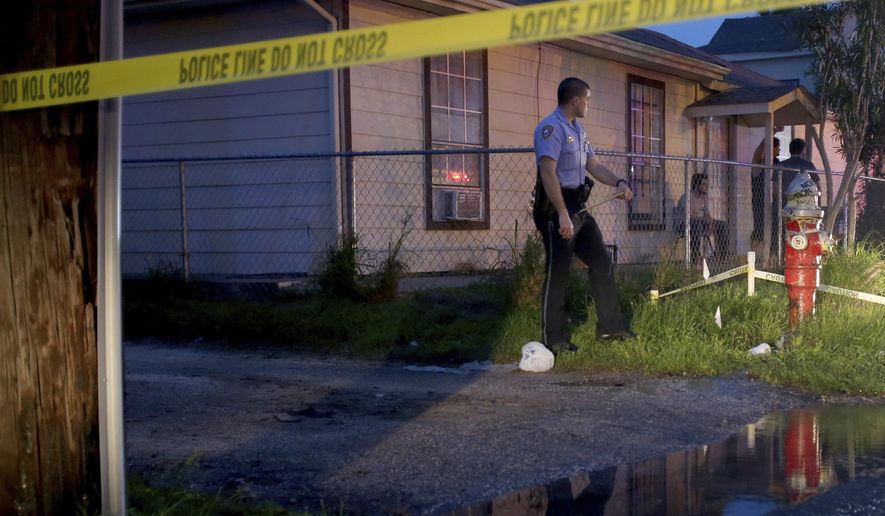 A Galveston police officer monitors the scene where an off-duty officer shot and killed a woman following a disturbance Thursday, March, 9, 2017, in Galveston, Texas. Galveston police Lt. Joshua Schirard tells KHOU-TV the incident occurred Thursday evening. He says the officer was out with family members when he spotted the disturbance and confronted an armed female. (Jennifer Reynolds/The Galveston County Daily News via AP)