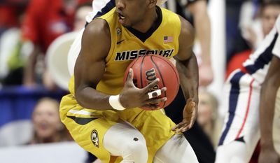Missouri guard Terrence Phillips, front protects the ball from Mississippi&#39;s Cullen Neal, top, during the first half of an NCAA college basketball game at the Southeastern Conference tournament Thursday, March 9, 2017, in Nashville, Tenn. (AP Photo/Wade Payne)
