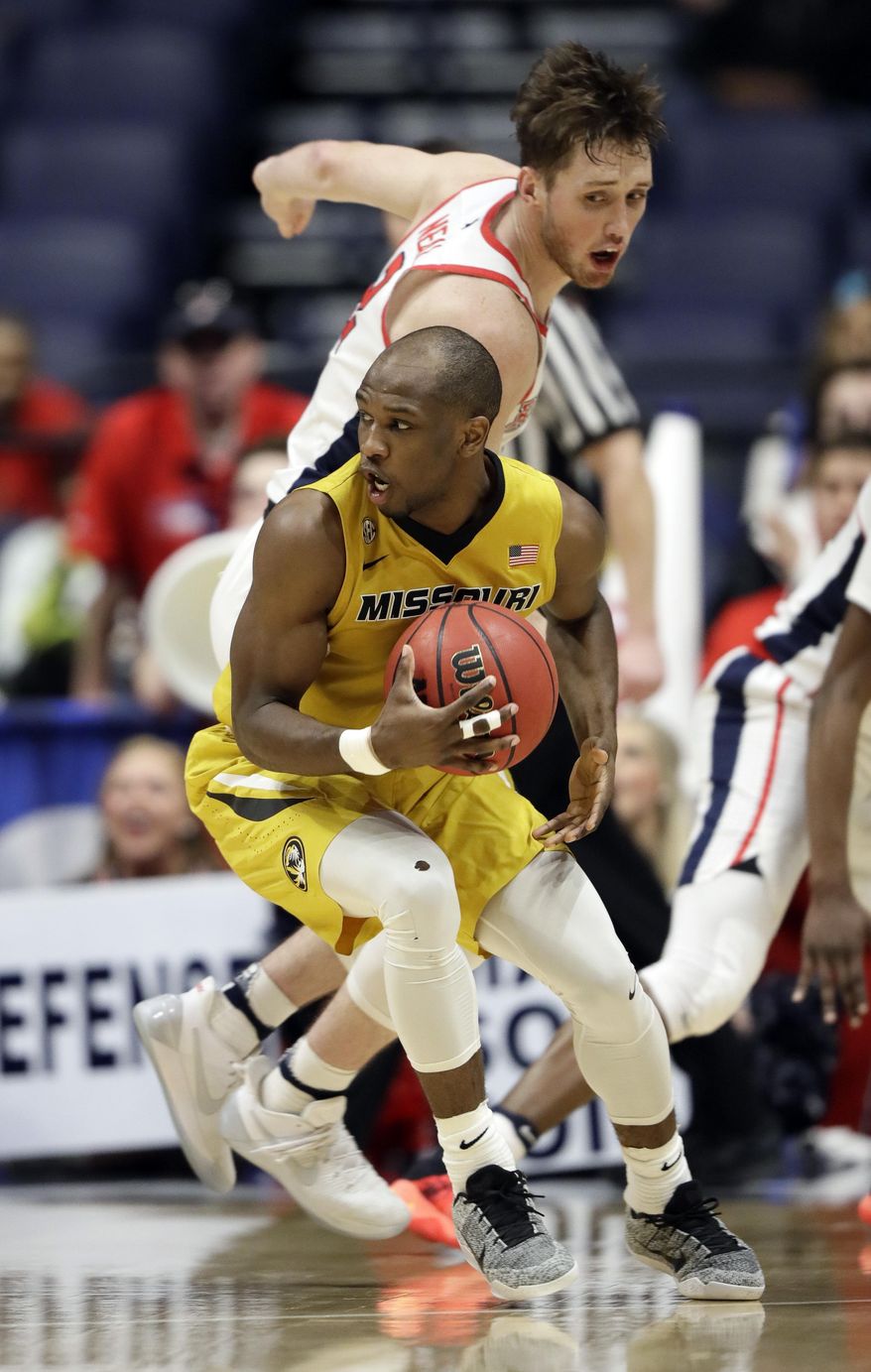 Missouri guard Terrence Phillips, front protects the ball from Mississippi&#39;s Cullen Neal, top, during the first half of an NCAA college basketball game at the Southeastern Conference tournament Thursday, March 9, 2017, in Nashville, Tenn. (AP Photo/Wade Payne)