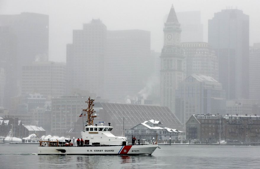 A U.S. Coast Guard boat patrols on Boston Harbor as snow falls, Friday morning, March 10, 2017, in Boston. Southeastern Massachusetts, most of Rhode Island and southeastern Connecticut are under winter storm warnings for much of Friday. (AP Photo/Michael Dwyer)
