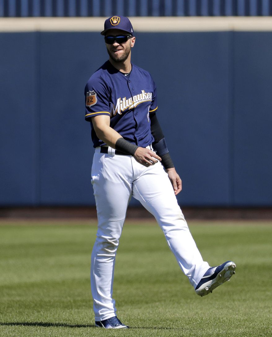Milwaukee Brewers left fielder Ryan Braun (8) stretches prior to a spring training baseball game against the Chicago White Sox, Friday, March 10, 2017, in Phoenix. (AP Photo/Matt York)