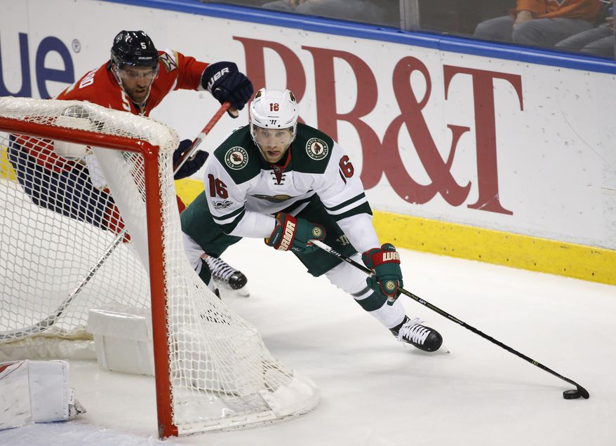 Minnesota Wild left wing Jason Zucker (16) and Florida Panthers defenseman Aaron Ekblad (5) battle for the puck during the first period of an NHL hockey game, Friday, March 10, 2017, in Sunrise, Fla. (AP Photo/Wilfredo Lee)