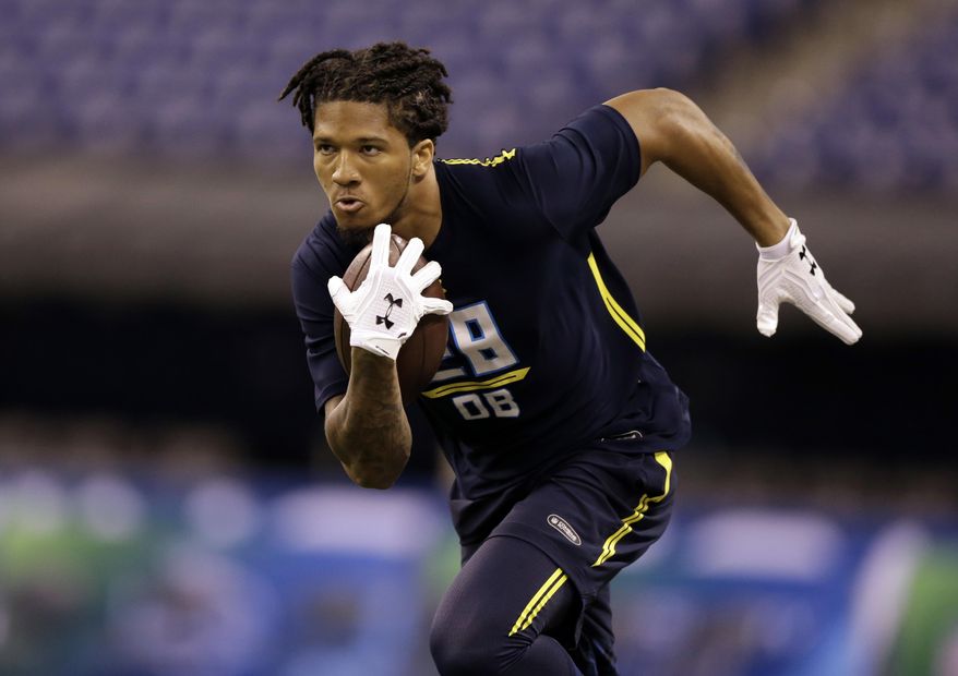 FILE - In this March 6, 2017, file photo, Washington defensive back Sidney Jones runs during the NFL football scouting combine in Indianapolis. Jones, a potential first-round draft pick, injured his left leg during defensive back drills in pro day workouts at the University of Washington on Saturday, March 11, 2017. (AP Photo/Michael Conroy, File)