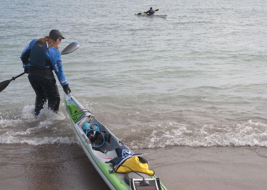 Traci Lynn Martin pulls her kayak into Lake Huron as she launches Thursday, March 9, 2017 at Lighthouse Beach in Port Huron, Mich., for her trip around the Great Lakes in 265 days. (Mark R. Rummel/The Times Herald via AP)