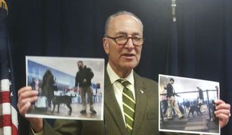 U.S. Sen. Charles Schumer holds up photos of anti-terrorism airport security dogs as he criticizes President Donald Trump Sunday, March 12, 2017, over proposed cuts to the Transportation Security Administration and Coast Guard that the New York Democrat says would put New York at risk, at Schumer&#39;s office in New York. The Democrat accused Trump&#39;s administration of seeking to slash important funding to free up money to fund a wall at the Mexican border. (AP Photo/Julie Walker)