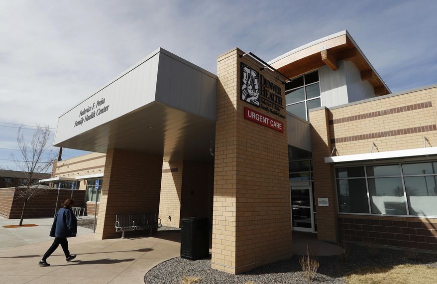 In this Thursday, March 9, 2017, photo, a patient heads into Denver Health Medical Center's primary care clinic located in a low-income neighborhood in southwest Denver. Under the new GOP health care proposal, which could roll back Medicaid expansion and take away subsidies to help pay for insurance, Denver Health could absorb a revenue loss, a problem that it will share with large public health systems across the country that serve low-income patients. (AP Photo/David Zalubowski)