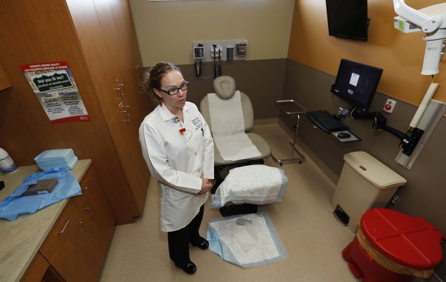 In this Thursday, March 9, 2017, photograph, Dr. Lindsey Fish waits for a patient in a procedure room in Denver Health Medical Center's primary care clinic located in a low-income neighborhood in southwest Denver. Under the new GOP health care proposal, which could roll back Medicaid expansion and take away subsidies to help pay for insurance, Denver Health could absorb a revenue loss, a problem that it will share with large public health systems across the country that serve low-income patients. (AP Photo/David Zalubowski)