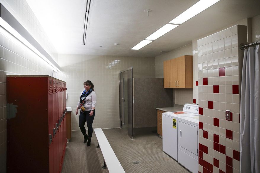 ADVANCE FOR USE SUNDAY, MARCH 12, 2017, AND THEREAFTER- In this March 10, 2017, photo, Assistant Principal Whitney Watchman gives a tour of one of two new wash rooms at East High School in Salt Lake City. The school is transforming two small locker rooms into laundry/shower rooms for the school's homeless students in hopes of helping them with basic necessities so they can focus on learning, KSL-Radio reported. (Spenser Heaps/The Deseret News via AP)