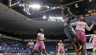 Troy guard ArJae&#39; Saunders (11) shoots between Louisiana-Lafayette forward Simone Fields (32) and guard/forward Gabby Alexander (22) during the first half of an NCAA college basketball game for the Sun Belt tournament title in New Orleans, Sunday, March 12, 2017.  (AP Photo/Gerald Herbert)