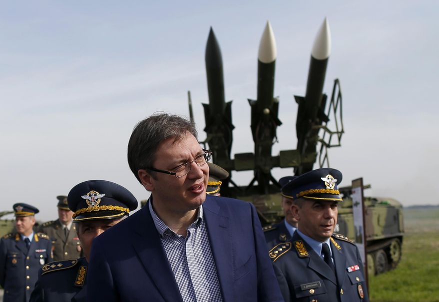 In this photo taken Wednesday, April 6, 2016, Serbia's Prime Minister Aleksandar Vucic inspects arms at the Batajnica military airport outside Belgrade, Serbia. Serbia's defense minister Zoran Djordjevic said Sunday, March 12, 2017, that the country is expecting Russian President Vladimir Putin's approval for the delivery of fighter jets, which could worsen tensions with neighboring states. (AP Photo/Darko Vojinovic)
