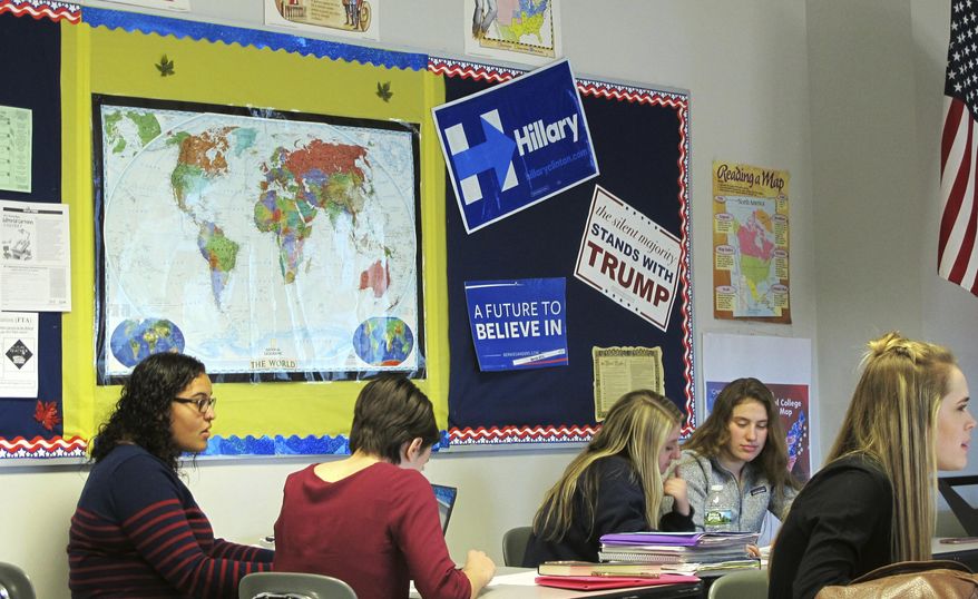 In this March 8, 2017 photo, campaign posters representing a variety of candidates are displayed in a classroom at Niagara Falls High School in Niagara Falls, N.Y. With current events increasingly dominating classroom discussions, there's a debate among educators whether it's appropriate for teachers to weigh in with their own political views. (AP Photo/Carolyn Thompson)