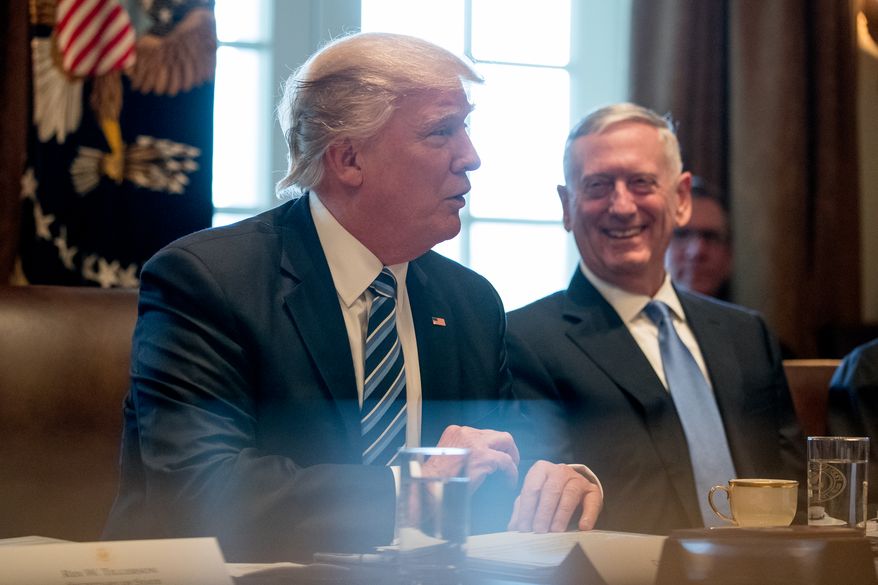 Defense Secretary Jim Mattis, right, smiles as President Donald Trump meets with members of his Cabinet in the Cabinet Room at the White House, Monday, March 13, 2017, in Washington. (AP Photo/Andrew Harnik)