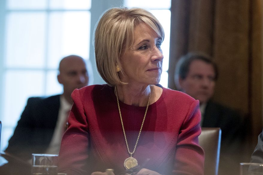 Education Secretary Betsy DeVos listens as President Donald Trump speaks during a Cabinet meeting in the Cabinet Room of the White House in Washington, Monday, March 13, 2017. (AP Photo/Andrew Harnik) ** FILE **