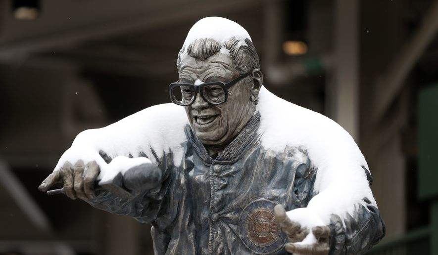The statue of Chicago Cubs' broadcaster Harry Carey outside Wrigley Field has a coating of snow on it as the Chicago area gets it's first measurable snow since December, Monday, March 13, 2017, in Chicago. Much of the Midwest and beyond is getting snow as part of a storm that forecasters say will yield between 3 to 6 inches of snow.(AP Photo/Charles Rex Arbogast) **FILE**