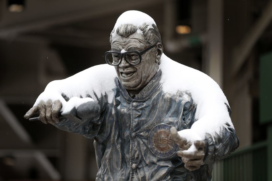 The statue of Chicago Cubs' broadcaster Harry Carey outside Wrigley Field has a coating of snow on it as the Chicago area gets it's first measurable snow since December, Monday, March 13, 2017, in Chicago. Much of the Midwest and beyond is getting snow as part of a storm that forecasters say will yield between 3 to 6 inches of snow.(AP Photo/Charles Rex Arbogast) **FILE**