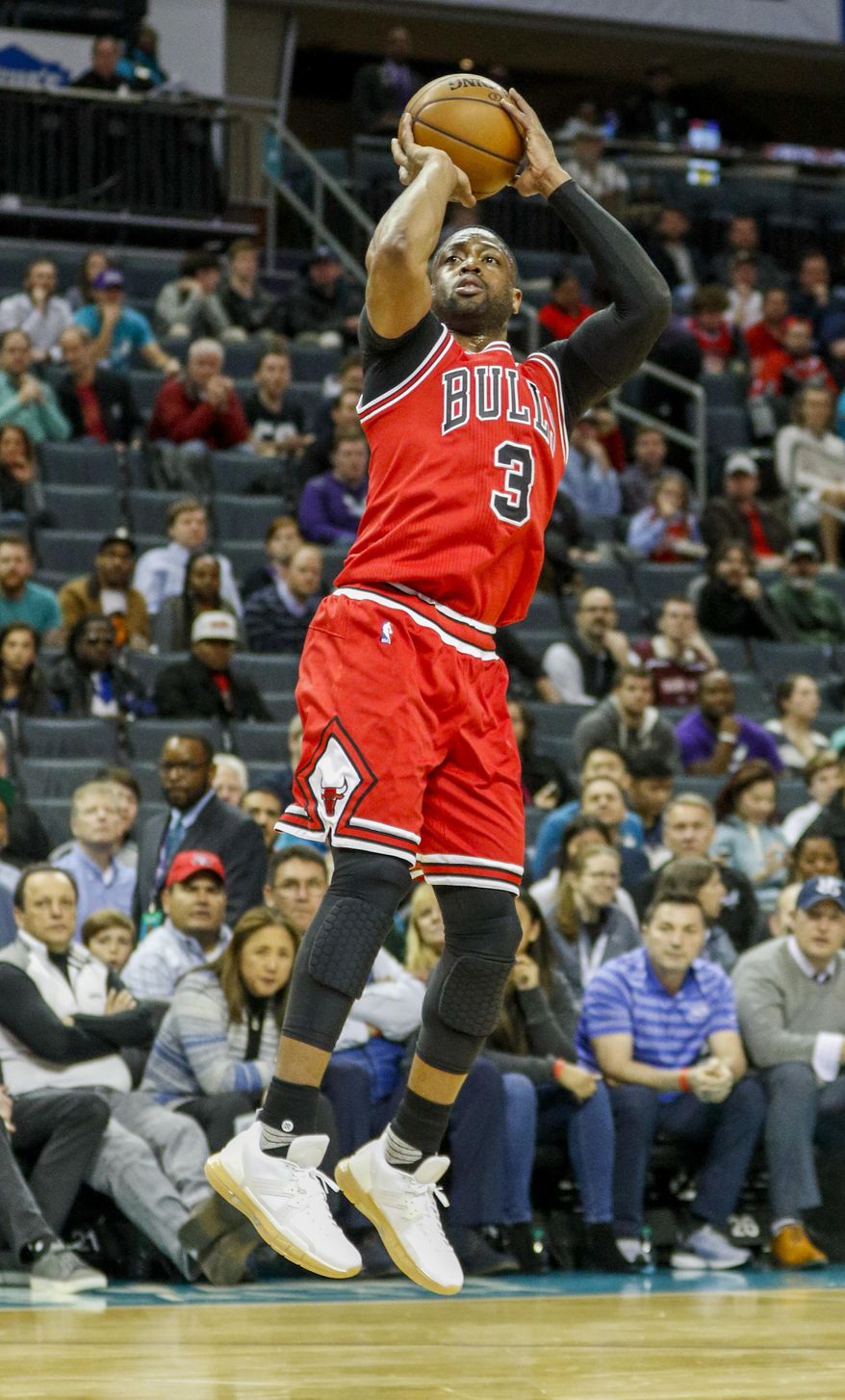 Chicago Bulls guard Dwyane Wade shoots a jump shot against the Charlotte Hornets in the first half of a NBA basketball game in Charlotte, N.C., Monday, March 13, 2017. (AP Photo/Nell Redmond)