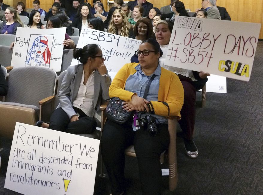 Supporters of SB54, which would create a statewide sanctuary for immigrants in the country illegally, prepare to testify for the measure in the Senate Appropriations Committee in Sacramento, Calif., Monday, March 13, 2017. The committee set the bill for a vote by the full Senate later this month. (AP Photo/Don Thompson)