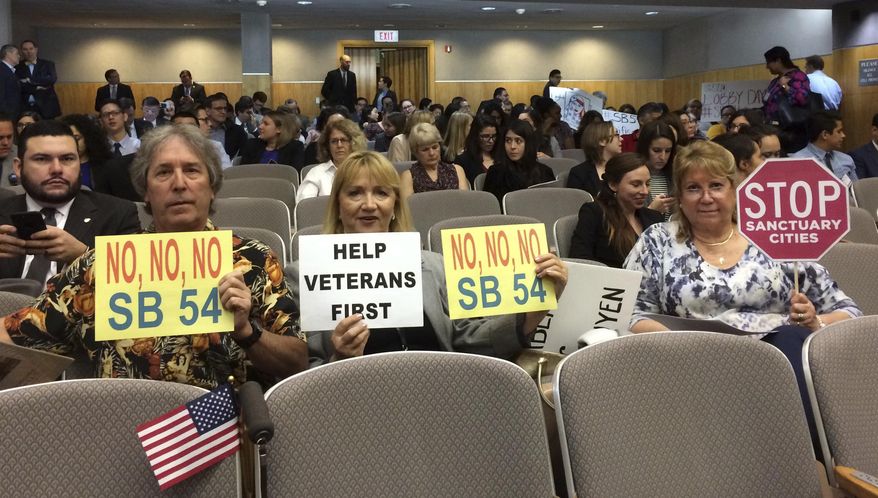 Opponents of SB54, which would create a statewide sanctuary for immigrants in the country illegally, prepare to testify against the measure in the Senate Appropriations Committee in Sacramento, Calif., Monday, March 13, 2017. The committee set the bill for a vote by the full Senate later this month. (AP Photo/Don Thompson)
