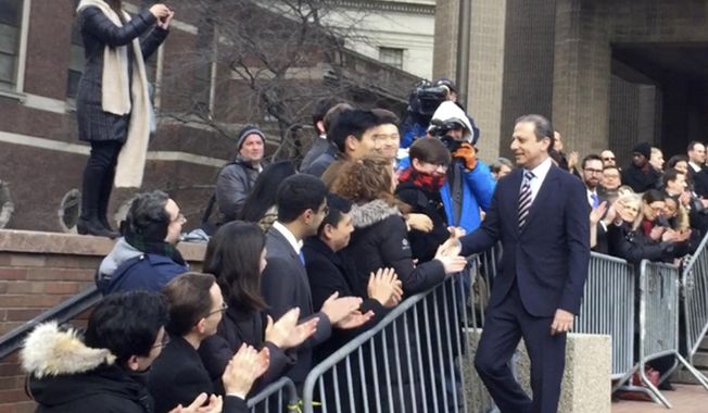In this image made from a video, former U.S. Attorney for the Southern District of New York Preet Bharara, walks down a line of applauding well-wishers Monday, March 13, 2017, in front of the New York office where he worked until he was fired by President Donald Trump's administration over the weekend after refusing to resign. (AP Photo/Larry Neumeister)