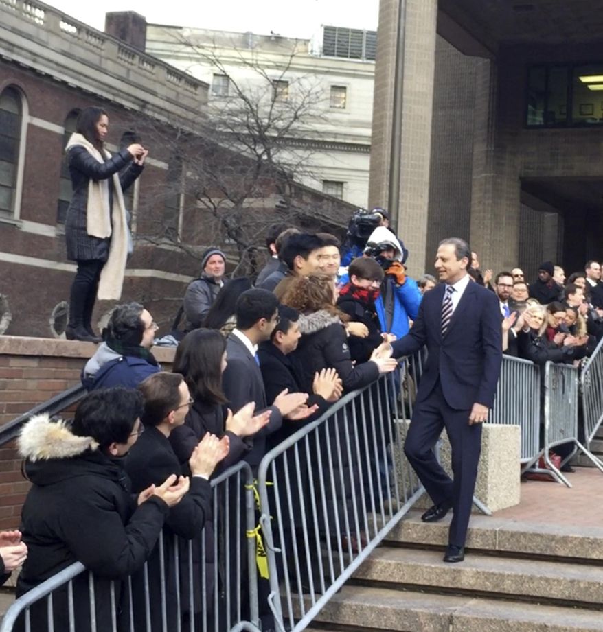 In this image made from a video, former U.S. Attorney for the Southern District of New York Preet Bharara, walks down a line of applauding well-wishers Monday, March 13, 2017, in front of the New York office where he worked until he was fired by President Donald Trump's administration over the weekend after refusing to resign. (AP Photo/Larry Neumeister)