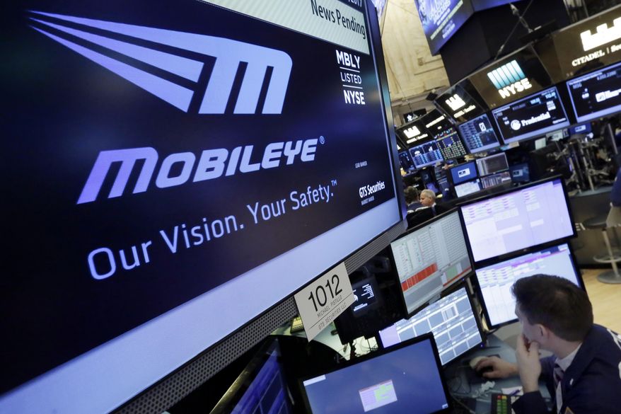 The Mobileye logo appears on a screen at the post where it trades on the floor of the New York Stock Exchange, Monday, March 13, 2017. Intel will buy Israel's Mobileye in a deal valued at just over $14 billion, the latest push by a major tech company to advance autonomous vehicles that could change the way traffic moves globally. (AP Photo/Richard Drew)