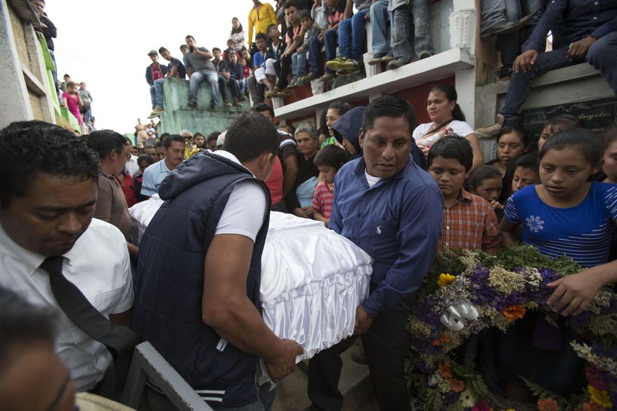 People carry the coffin of 14-year-old Ana Roselia Perez Junay, who died in a fire at a children's shelter, at the cemetery in Zaragoza, Guatemala, Sunday, March 12, 2017. The death toll in the March 8 fire rose to 40 on Sunday with the announcement that another girl has died of burns. (AP Photo/Moises Castillo)