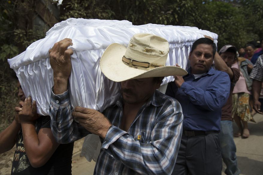 People carry the coffin containing the remains of 14-year-old Ana Roselia Perez Junay, who died in a fire at a children's shelter, to the cemetery in Zaragoza, Guatemala, Sunday, March 12, 2017. The death toll in the March 8 fire rose to 40 on Sunday with the announcement that another girl has died of burns. (AP Photo/Moises Castillo)