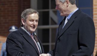 Massachusetts Governor Charlie Baker, right, shakes hands with Irish Taoiseach Enda Kenny as he arrives at the Massachusetts Statehouse, Monday, March 13, 2017, in Boston. (AP Photo/Elise Amendola)