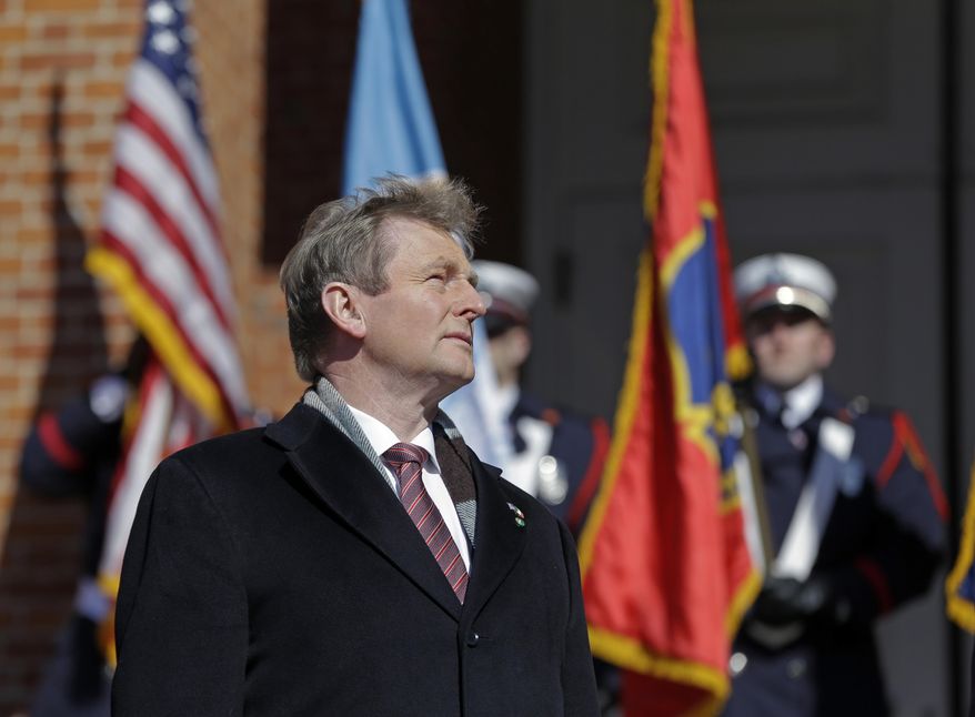 Irish Taoiseach Enda Kenny listen to the Irish national anthem after his arrival at the Massachusetts Statehouse, Monday, March 13, 2017, in Boston. (AP Photo/Elise Amendola)