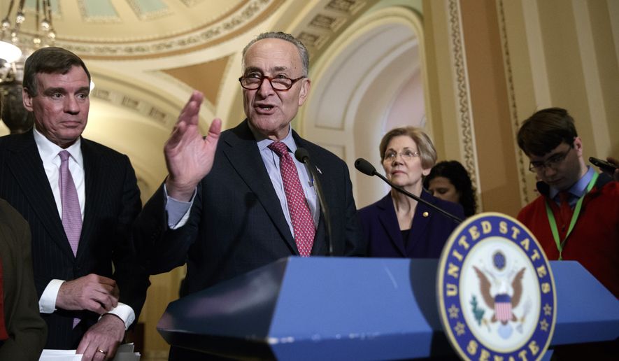 Senate Minority Leader Chuck Schumer, D-N.Y., joined by Sen. Mark Warner, D-Va., left, and Sen. Elizabeth Warren, D-Mass., right, speaks at the Capitol in Washington, Tuesday, March, 14, 2017. The White House and Republican leaders in Congress are scrambling to shore up support for their health care bill after findings from the Congressional Budget Office estimated that 14 million people would lose insurance coverage in the first year alone under the GOP replacement for Obamacare. (AP Photo/J. Scott Applewhite)