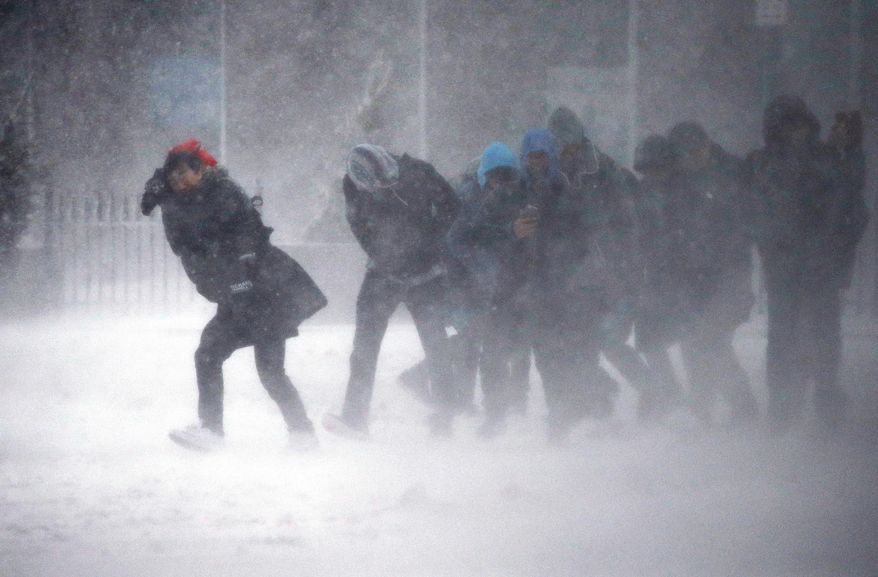 People struggle to walk in the blowing snow during a winter storm Tuesday, March 14, 2017, in Boston. (AP Photo/Michael Dwyer)