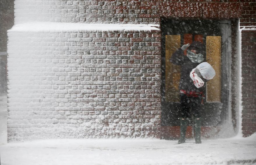 A person stands in the wind-driven snow during a winter storm Tuesday, March 14, 2017, in Boston. (AP Photo/Michael Dwyer)