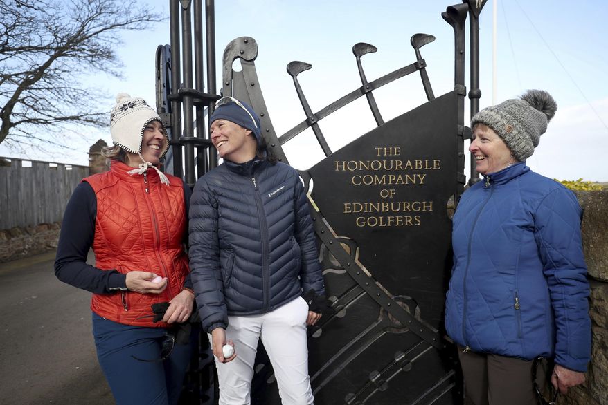 Holidaymakers Anna Dietrich, Pascale Reinhard and Jeanette Siehenthiler, from left, smile after playing a round of golf following the announcement that women will be admitted as members of Muirfield Golf Club after a membership ballot was held by The Honourable Company of Edinburgh Golfers, in Gullane, Scotland Tuesday, March 14, 2017. Muirfield Golf Club voted Tuesday to admit female members for the first time in its 273-year history, paving the way for the Scottish golf club to again host the British Open. ( Jane Barlow/PA via AP)