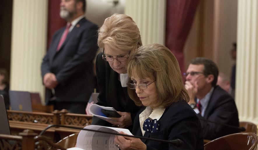 FILE - In this Aug. 26, 2016 file photo, Senate Minority Leader Jean Fuller, R-Bakersfield, left, huddles with Sen. Patricia Bates, R-Laguna Niguel, at the Capitol, in Sacramento, Calif. The Senate Republicans announced, Tuesday March 14, 2017, that they have elected Bates to succeed Fuller as leader of the Senate GOP effective in April. (AP Photo/Rich Pedroncelli)