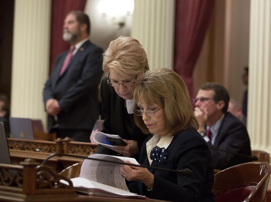 FILE - In this Aug. 26, 2016 file photo, Senate Minority Leader Jean Fuller, R-Bakersfield, left, huddles with Sen. Patricia Bates, R-Laguna Niguel, at the Capitol, in Sacramento, Calif. The Senate Republicans announced, Tuesday March 14, 2017, that they have elected Bates to succeed Fuller as leader of the Senate GOP effective in April. (AP Photo/Rich Pedroncelli)