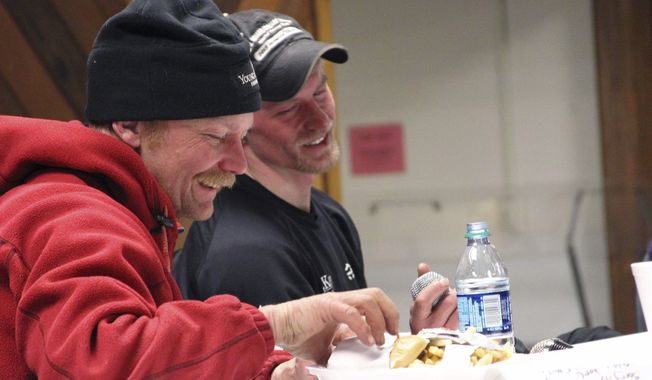 FILE - In this March 15, 2016, file photo, Mitch Seavey, left, and Dallas Seavey speak to fans after the Iditarod Trail Sled Dog Race in Nome, Alaska. Mitch Seavey had a commanding two-hour lead Tuesday, March 14, 2017, in the 2017 Iditarod, and was nearing the finish line. If the lead holds, he and his son, Dallas, will have won the last six sled dog races across nearly a thousand miles of grueling Alaska wilderness. (AP Photo/Mark Thiessen, File)