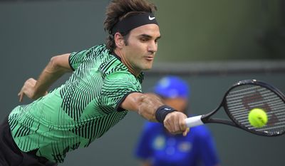 Roger Federer, of Switzerland, returns a shot to Steve Johnson at the BNP Paribas Open tennis tournament, Tuesday, March 14, 2017, in Indian Wells, Calif. (AP Photo/Mark J. Terrill)