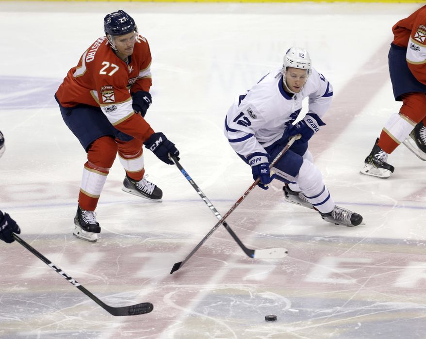Florida Panthers center Nick Bjugstad (27) battles Toronto Maple Leafs right wing Connor Brown (12) for the puck in the first period of an NHL hockey game, Tuesday, March 14, 2017, in Sunrise, Fla. (AP Photo/Alan Diaz)