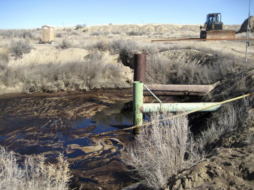 This photo supplied by the Environmental Protection Agency shows oil trapped by a berm and siphon dam in a dry ravine where the oil from a Chevron spill was stopped March 7, 2017, near Rangely, Colo. Chevron Corp. says its crews are cleaning up about 4,800 gallons of oil that spilled from a failed pipeline into an intermittent stream on public land in northwestern Colorado. State officials said Tuesday, March 14, 2017, that the oil travelled about 2 miles downstream along an unnamed tributary of Stinking Water Creek in Rio Blanco County. (Environmental Protection Agency via AP)