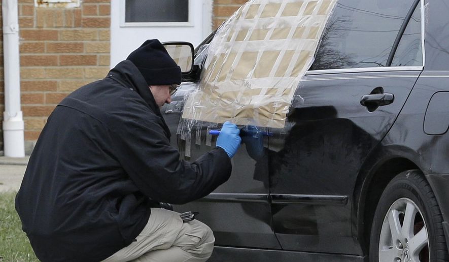 A Bureau of Criminal Investigation investigator collect evidence near a vehicle after a shooting, Monday, March 13, 2017, in Euclid, Ohio. Police say an officer responding to a report of a suspicious vehicle fatally shot a man. Euclid police say the shooting occurred around 7 am Monday. Police say they believe the man who was killed was in his 20's. An officer was taken to a hospital for medical evaluation and released. (AP Photo/Tony Dejak)