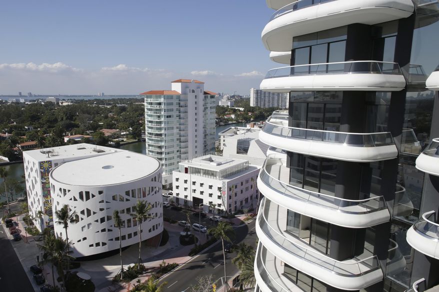 In this Tuesday, Feb. 14, 2017 photo, Faena Forum, left, and Faena House, right, are shown in the Mid-Beach neighborhood of Miami Beach, Fla. They are part of a cluster of buildings developed by Argentine hotel magnate Alan Faena, where decaying structures and empty parking lots are giving way to opulent hotels, condos, and a performing arts center. (AP Photo/Lynne Sladky)