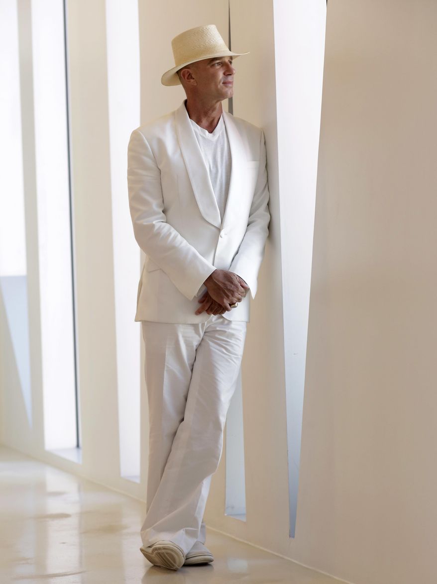 In this Tuesday, Feb. 14, 2017 photo, Argentine hotel magnate Alan Faena poses for a photograph in the Faena Forum, a performance and cultural center in the Faena District in Miami Beach, Fla. The center is part of a cluster of buildings developed by Faena, where decaying structures and empty parking lots are giving way to opulent hotels, condos, and a performing arts center. (AP Photo/Lynne Sladky)