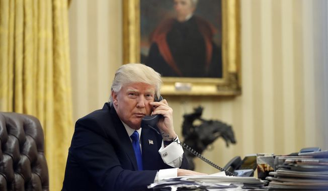 In this Saturday, Jan. 28, 2017 photo, President Donald Trump speaks on the telephone with Australian Prime Minister Malcolm Turnbull in the Oval Office of the White House in Washington. (AP Photo/Alex Brandon, File)