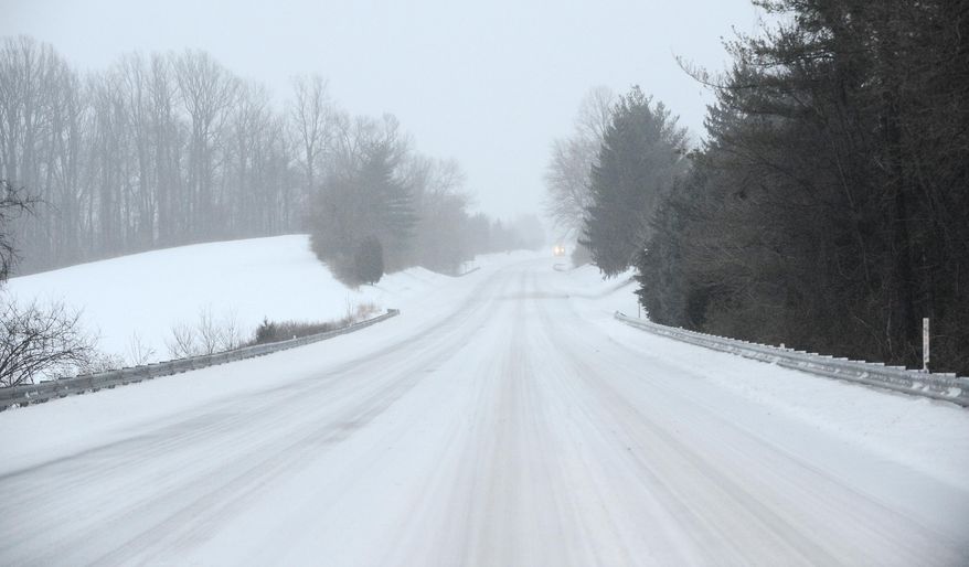Snow covers Route 97 in Westminster, Md., as sleet falls Tuesday morning, March 14, 2017. (Dylan Slagle/The Baltimore Sun via AP)