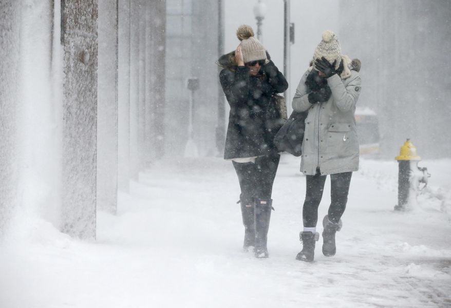 Two women struggle to walk in the blowing snow during a winter storm Tuesday, March 14, 2017, in Boston. (AP Photo/Michael Dwyer)
